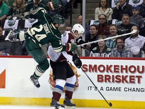Wild forward Matt Cooke (left) collides with Avalanche defenceman Nick Holden during Game 3 on Monday. (Brace Hemmelgarn/USA Today Sports)