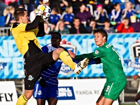 Edmonton keeper John Smits makes a save in front of New York's Mads Stokkelien during FC Edmonton's game against the New York Cosmos at Clarke Stadium Saturday. (Codie McLachlan, Edmonton Sun)
