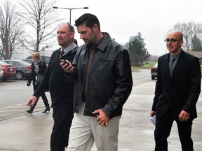 The four Ontario Provincial Police constables involved in the May 2012 call to the Matthew Roke incident leave St. Lawrence College after the first day of the inquest into Roke's death. From left are Jason Sparks, Michael Wraight, Francis Robitaille (with phone) and Vince Oickle. A jury has classified Roke's death as a homicide (Recorder and Times file photo).
