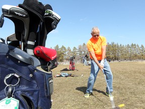 Ken Holberg hits a ball on the driving range at Shooters Golf Centre in Winnipeg. (BRIAN DONOGH/Winnipeg Sun)