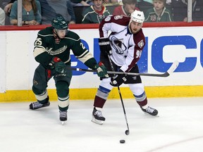 Colorado Avalanche forward Ryan O'Reilly (90) passes around Minnesota Wild defenceman Jonas Brodin (25) during the second period in game three of the first round of the 2014 Stanley Cup Playoffs at Xcel Energy Center. (Brace Hemmelgarn-USA TODAY Sports)