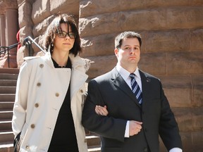Toronto Police Const. James Forcillo, with wife Irini, leaves Old City Hall in Toronto Tuesday, April 22, 2014 after a preliminary hearing into the shooting death of Sammy Yatim aboard a TTC streetcar last July. (Stan Behal/Toronto Sun)