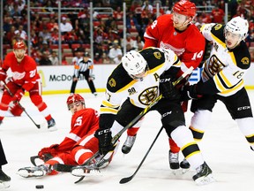 Boston Bruins centre Patrice Bergeron and right wing Reilly Smith (right) battle for the puck with Detroit Red Wings centre Gustav Nyquist during Game 3 of their Eastern Conference quarterfinal series at Joe Louis Arena in Detroit, April 22, 2014. (RICK OSENTOSKI/USA Today)