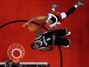 DeMar DeRozan of the Toronto Raptors gets over Andray Blatche of the Brooklyn Nets during Game 2 of the Eastern Conference playoffs at the Air Canada Centre in Toronto Tuesday, April 22, 2014. Dave Abel/Toronto Sun/QMI Agency