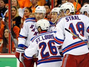 New York Rangers centre Derek Stepan celebrates with left wing Rick Nash (left), right wing Martin St. Louis, and defenceman Marc Staal after scoring a goal against the Philadelphia Flyers in Game 3 of their Eastern Conference quarterfinal series at the Wells Fargo Center in Philadelphia, April 22, 2014. (ERIC HARTLINE/USA Today)