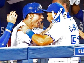 Jays third baseman Brett Lawrie celebrates his three-run homer with Melky Cabrera during last night’s game. Lawrie is batting a meek .135, but leads the team in RBIs and has four homers this season. (MICHAEL PEAKE/Toronto Sun)