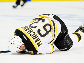 Boston Bruins forward Brad Marchand lays on the ice after being tripped by Detroit Red Wings defenceman Brandon Smith during Game 3 of their Eastern Conference quarterfinal series at Joe Louis Arena in Detroit, April 22, 2014. (USA Today)