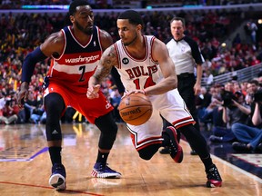 Chicago Bulls guard D.J. Augustin dribbles the ball against Washington Wizards guard John Wall during Game 2 of their Eastern Conference quarterfinal series at the United Center in Chicago, April 22, 2014. (MIKE DiNOVO/USA Today)