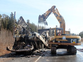 Clean up crews begin the job of removing the smoldering wreckage of a semi-trailer fire which closed the highway on Tuesday night, April 22.