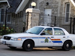 An RCMP cruiser is parked in front of the official residence to the Prime Minister of Canada at 24 Sussex Dr.  in Ottawa in this August 2, 2013 file photo. (Darren Brown/QMI Agency)