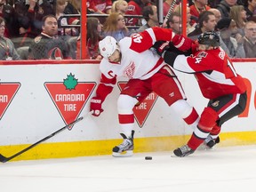 Detroit Red Wings captain Henrik Zetterberg (40) and Ottawa Senators forward Colin Greening battle for control of the puck  at the Canadian Tire Centre. (Marc DesRosiers/USA TODAY Sports)