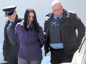 Former elementary school teacher Kim Gervais, 37, of Timmins, is led by officers from the Timmins Superior Court of Justice on Wednesday after pleading guilty to sex charges involving four young male students. She was sentenced to seven months in jail, followed by two years of probation.