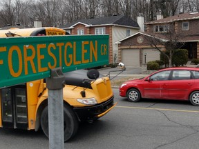 A school bus passes Forestglen Cr in Orléans On. Wednesday April 22,  2014. Many Ottawans are upset that cars pass his kids school bus everyday even though the red lights are flashing. Tony Caldwell/Ottawa Sun