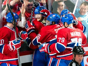 Montreal Canadiens winger Max Pacioretty is mobbed by teammates after scoring the series-clinching overtime goal against the Tampa Bay Lightning in Game 4 of their Eastern Conference quarterfinal series at the Bell Centre in Montreal, April 22, 2014. (PIERRE-PAUL POULIN/QMI Agency)