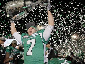 Saskatchewan Roughriders Weston Dressler hoists the Grey Cup after beating the Hamilton Tiger-Cats in the 101st CFL Grey Cup in Regina, Sask., on Sunday November 24, 2013. Lyle Aspinall/Calgary Sun/QMI Agency