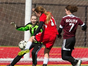 South goalie Elaine Pityn is the last line of defence as Medway?s Quinn Karasek tries to get her foot on an awkward ball while being pursued by Natalie Evans of South during their TVRA Central girls? soccer game at the City Wide fields on Wednesday. On another windy day, South climbed out to a 2-0 lead in the first half with the wind at their backs, but in the second half Medway roared back with three tallies to win 3-2. (Mike Hensen/The London Free Press)