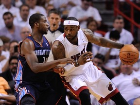 Miami Heat forward LeBron James is pressured by Charlotte Bobcats forward Michael Kidd-Gilchrist in Game 2 of their Eastern Conference quarterfinal series at American Airlines Arena in Miami, April 23, 2014. (STEVE MITCHELL/USA Today)