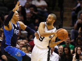 San Antonio Spurs guard Tony Parker looks to pass the ball around Dallas Mavericks forward Shawn Marion during Game 2 of their Western Conference quarterfinal series at the AT&T Center in San Antonio, April 23, 2014. (SOOBUM IM/USA Today)