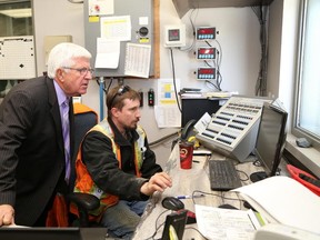 JOHN LAPPA/THE SUDBURY STAR
Sudbury MPP Rick Bartolucci, left, looks on as batch plant operator Ryan Punstel works at his station at the Interconcrete Limited site in Garson on Wednesday. Bartolucci announced $1 million in funding for the company during a tour of the facilities. See video at www.thesudburystar.com.