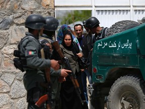 Women leave the Cure Hospital after three foreigners were killed in Kabul April 24, 2014. REUTERS/Mohammad