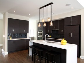 The Massey is a model home by Uniform Urban Developments in Richardson Ridge in Kanata. The kitchen is sleek and contemporary.