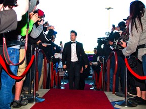 Canadian actor Cody Hackman walks through a throng of cameras and autograph seekers as he enters the Masonville SilverCity on the red carpet for the advanced screening of his movie Tapped Out in London, Ont. on Wednesday April 23, 2014. (MIKE HENSEN, The London Free Press)