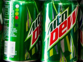 Cans of Mountain Dew are displayed in a case. 
REUTERS/Sam Hodgson