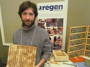 Shawn McKnight spoke at Thursday's Sustainable Communities Conference, held at Lambton College, about a Regen social enterprise project he has been developing to make new products out of used materials — such as the wine cork board he's holding. The conference was hosted by the Bluewater Sustainability Initiative. PAUL MORDEN/THE OBSERVER/QMI AGENCY