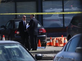 The body of a shooting victim is covered by an orange blanket in the parking lot of a cafe on Regina Rd. in Vaughan on April 24, 2014. (Dave Thomas/Toronto Sun)