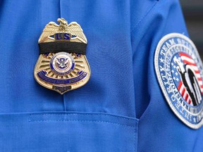 A Transportation Security Administration (TSA) agent wears a black ribbon over his badge during a memorial service for his colleague Gerardo Hernandez.

REUTERS/Kevork Djansezian