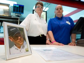 Ruth Bogue, left, and her daughter Becca Rigby stand next to a photo of their respective brother and uncle, David Martin, who passed away suddenly from brain cancer in March.  The pair placed a jar on the counter of the Arby's they work at in Masonville Place, only to discover the jar and money were stolen earlier this week.  CRAIG GLOVER/The London Free Press/QMI Agency