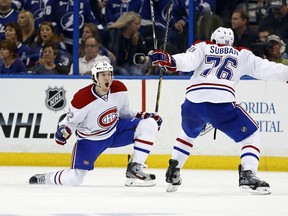 Dale Weise (left) celebrates his overtime winner in Game 1 against Tampa Bay. The Winnipegger grew up in a Habs family and his parents home is decorated in the team colours. (MIKE CARLSON/Getty Images/AFP)