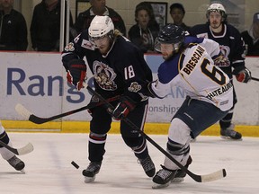 Dauphin Kings forward Brett Wold (left) and Winnipeg South Blues defenceman Channing Bresciani battle for the puck during Game 3 of the MJHL final at MTS Iceplex in Headingley, Man., on Fri., April 11, 2014. Kevin King/Winnipeg Sun/QMI Agency