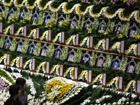 Mourners look at the portraits of victims onboard capsized passenger ship Sewol at a temporary group memorial altar in Ansan April 24, 2014.   REUTERS/Kim Hong-Ji