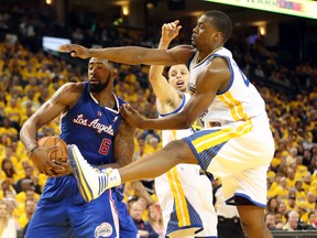 Los Angeles Clippers centre DeAndre Jordan controls a rebound against Golden State Warriors guard Stephen Curry (back) and forward Harrison Barnes during Game 3 of their Western Conference quarterfinal series at Oracle Arena in Oakland, April 24, 2014. (KELLEY L. COX/USA Today)