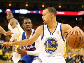 Golden State Warriors guard Stephen Curry controls the ball ahead of Los Angeles Clippers guard Chris Paul during the second quarter of Game 3 of the first round of the 2014 NBA playoffs at Oracle Arena. (Kelley L Cox/USA TODAY Sports)