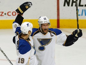 St. Louis Blues' David Backes celebrates his goal with teammate Jay Bouwmeester against the Chicago Blackhawks during the third period of their NHL hockey game April 4, 2013. (REUTERS/Jim Young)
