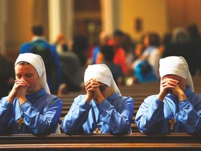 Three nuns pray after the conclusion of Easter Mass at the Cathedral of the Holy Cross in Boston, Massachusetts. (REUTERS file photo)