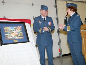 8 Air Communication and Control Squadron presiding officer Major Jeff Szumlanksi presents a gift to outgoing honourary colonel Maureen Piercy, Friday during a change of command ceremony at 8 Wing Trenton. 
Emily Mountney/The Intelligencer/QMI Agency