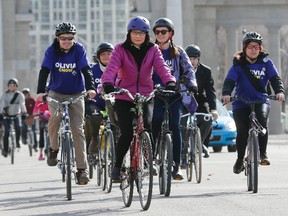Toronto mayoral candidate Olivia Chow arrives by bicycle at the Green Living Show at Exhibition Place on April 25, 2014. She was accompanied by a large group of bike-riding supporters. Chow says she plans to improve the tree canopy at no cost to the taxpayer by removing subsidies on polluters. (Stan Behal/Toronto Sun)