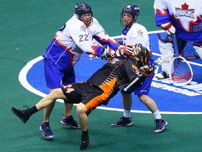 Rock defender Cam Woods, decking Buffalo Bandits' Mitch Jones in a game earlier this month, says his team finally has everyone playing at a high level. (Dave Abel, Toronto Sun)