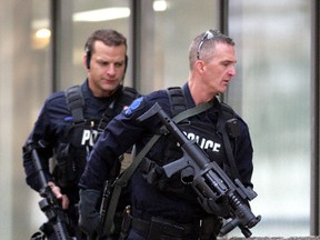 Edmonton, AB. October 21, 2009: Edmonton Police Service SWAT team members move into position after being called to a hostage situation at the Workers' Compensation Board building, 9912 - 107 St., in Edmonton Wednesday morning. David Bloom/Sun Media
