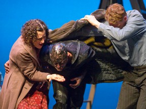 Ena, played by Alison Woolridge, left, and John Pike, played by Jody Richardson, right, help an ailing Bergeron, played Clint Butler, after the sailor escaped from oil-slicked water following a maritime mishap in Oil and Water, playing at The Grand Theatre until May 10. (CRAIG GLOVER/The London Free Press)
