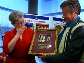 Paul Ducharme with the Royal Canadian Legion returns two stolen war medals to Ken McNay and his sister Dona Crawford, the children of Pte. Robert McNay, on April 25, 2014. (Dave Abel/Toronto Sun)