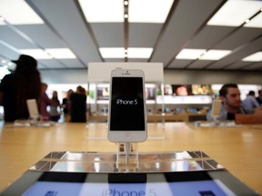 An iPhone 5 is pictured on display at an Apple Store in Pasadena, California July 22, 2013. (REUTERS/Mario Anzuoni)