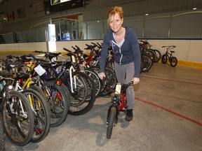 Marcia Fifer with some of the bicycles that will be for sale in the annual  auction on Saturday and Sunday.(Chris Procaylo/Winnipeg Sun)