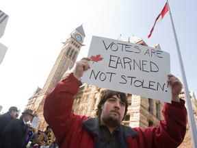 Demonstrators participate in a rally and march over the Robocall scandal, targeting the Conservative government in downtown Toronto in this March 31, 2012 file photo in the downtown core. (Jack Boland/QMI Agency)