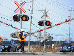 Via employees are stationed at Fallowfield railway crossing due to issues with them working properly as the afternoon train comes in. Sarah Taylor/Ottawa Sun/QMI Agency