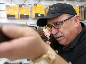 Gino Donato/The Sudbury Star
Mike Brisson, a sales associate at Kukagami Jack, aims a Browning 30-06 rifle, which would be perfect for bear hunting.