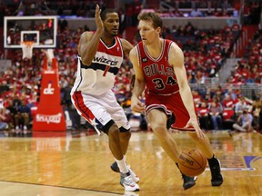 Chicago Bulls forward Mike Dunleavy dribbles the ball as Washington Wizards forward Trevor Ariza defends during Game 3 of their Eastern Conference quarterfinal series at the Verizon Center in Washington, D.C., April 25, 2014. (GEOFF BURKE/USA Today)